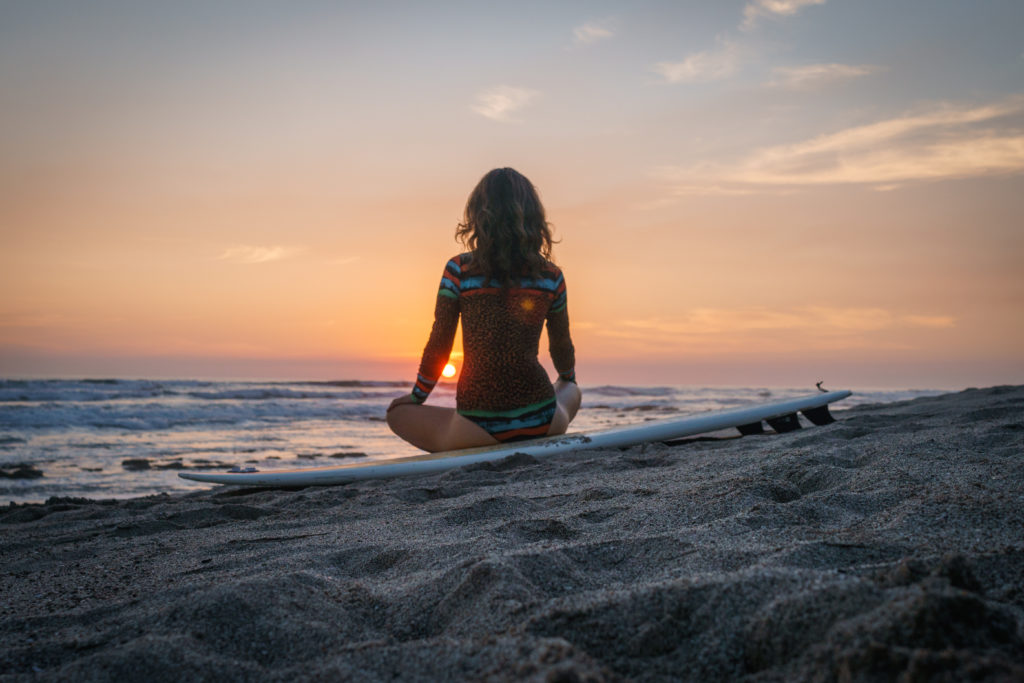 meditation on beach at sunset
